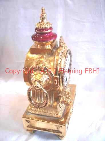 Front and left side of gilt mantel clock