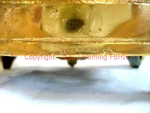 Cast-in case-maker's name of gilt mantel clock