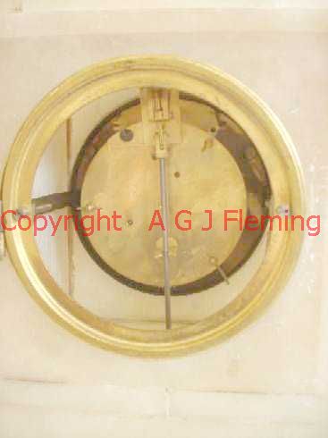 Back view of Alabaster clock with statues, rear cover open